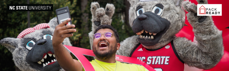 NC State student taking a selfie with mascots.